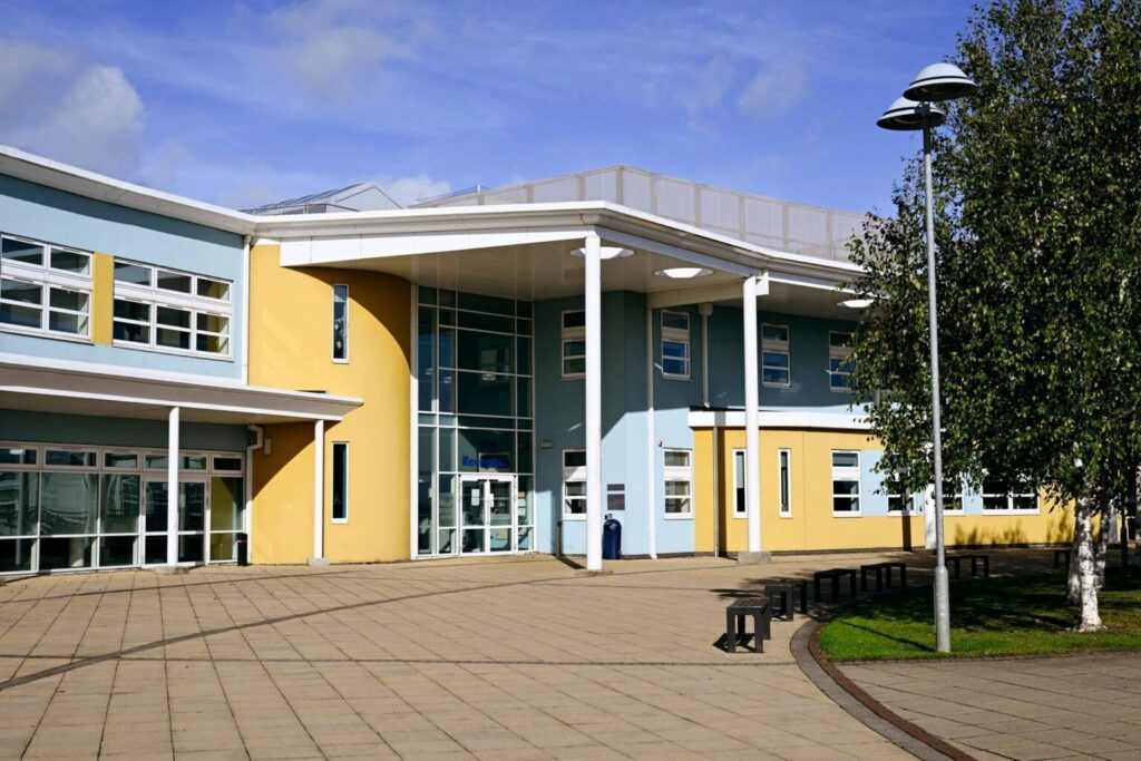 Modern school building with colorful exterior design.
