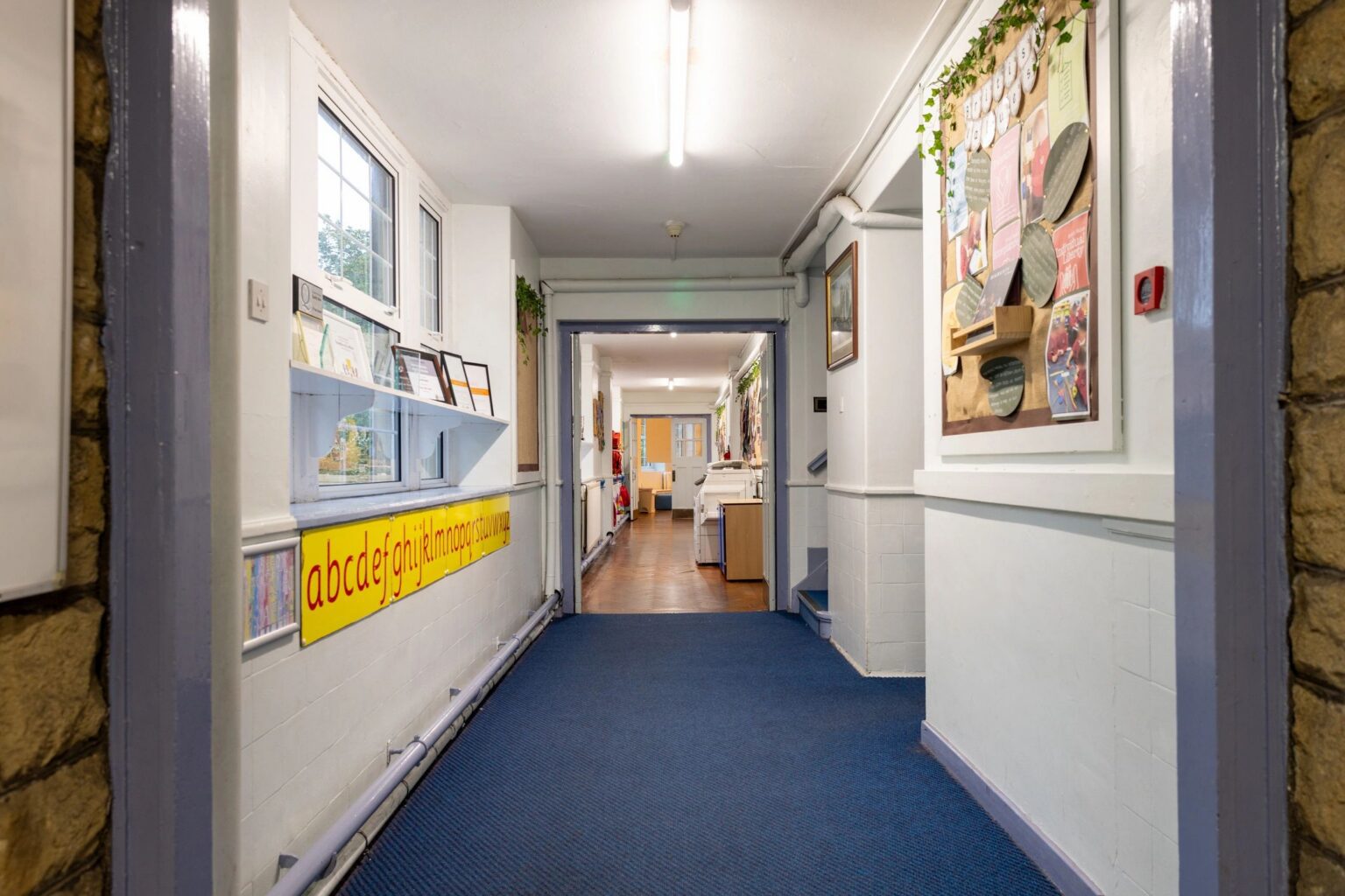 School hallway with colorful wall decorations.