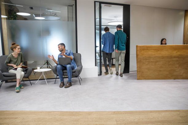 Office lobby with people and reception desk.