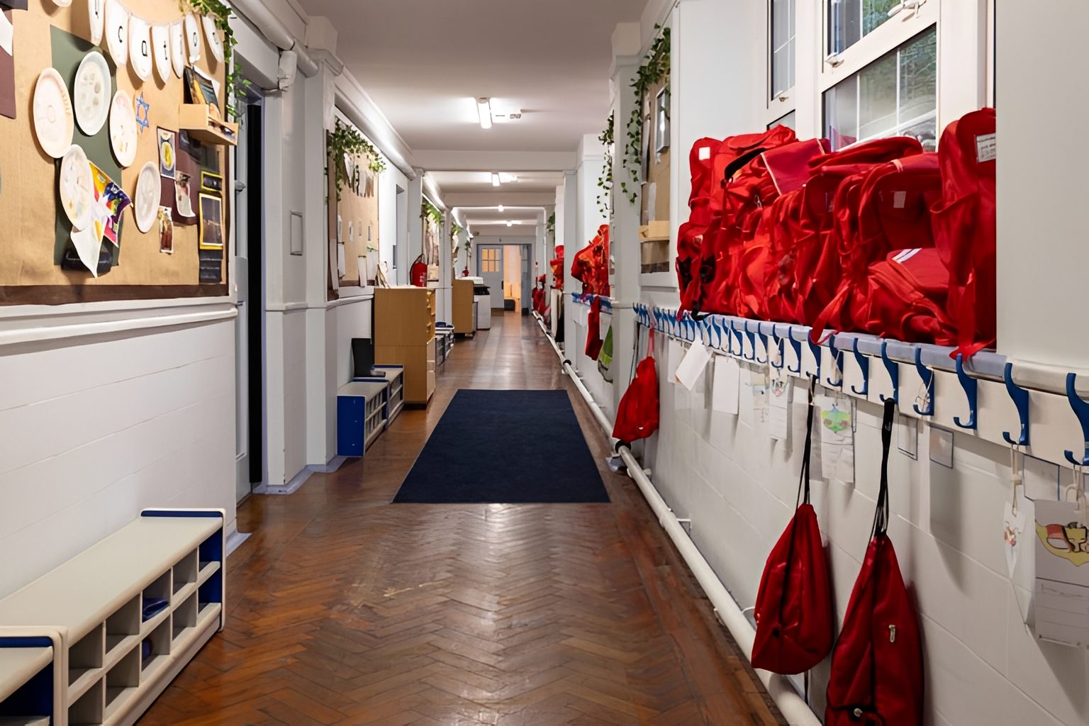 School hallway with red bags and artwork.