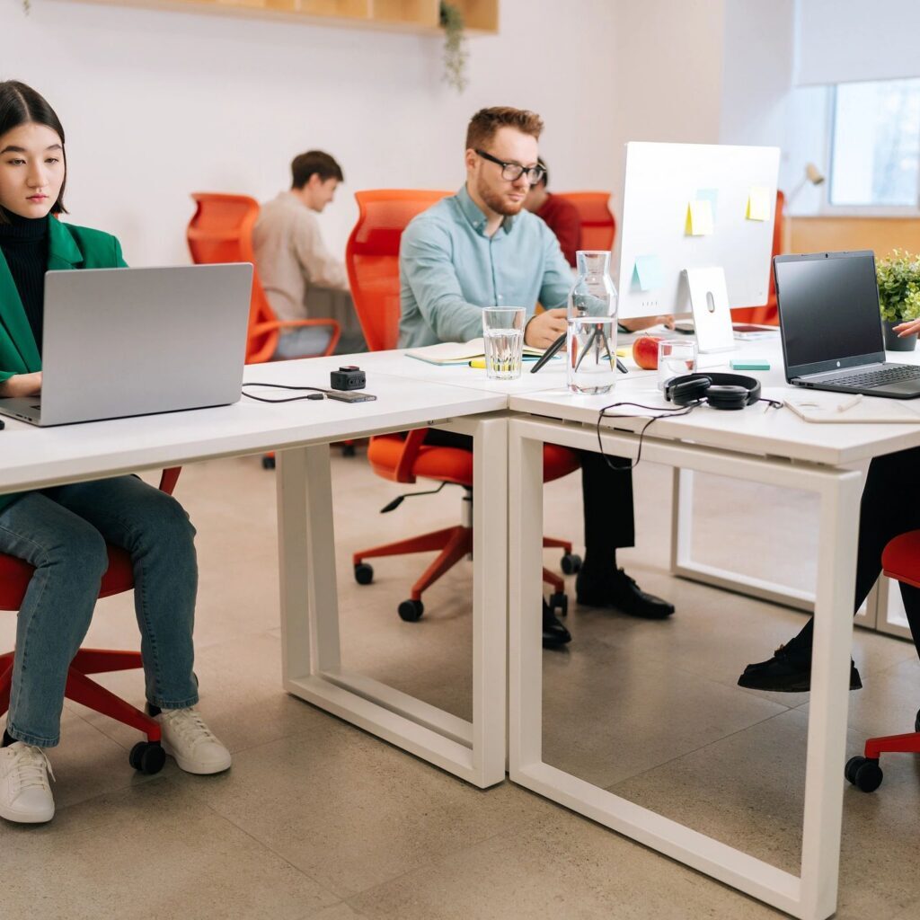 Office workers focused on their laptops.